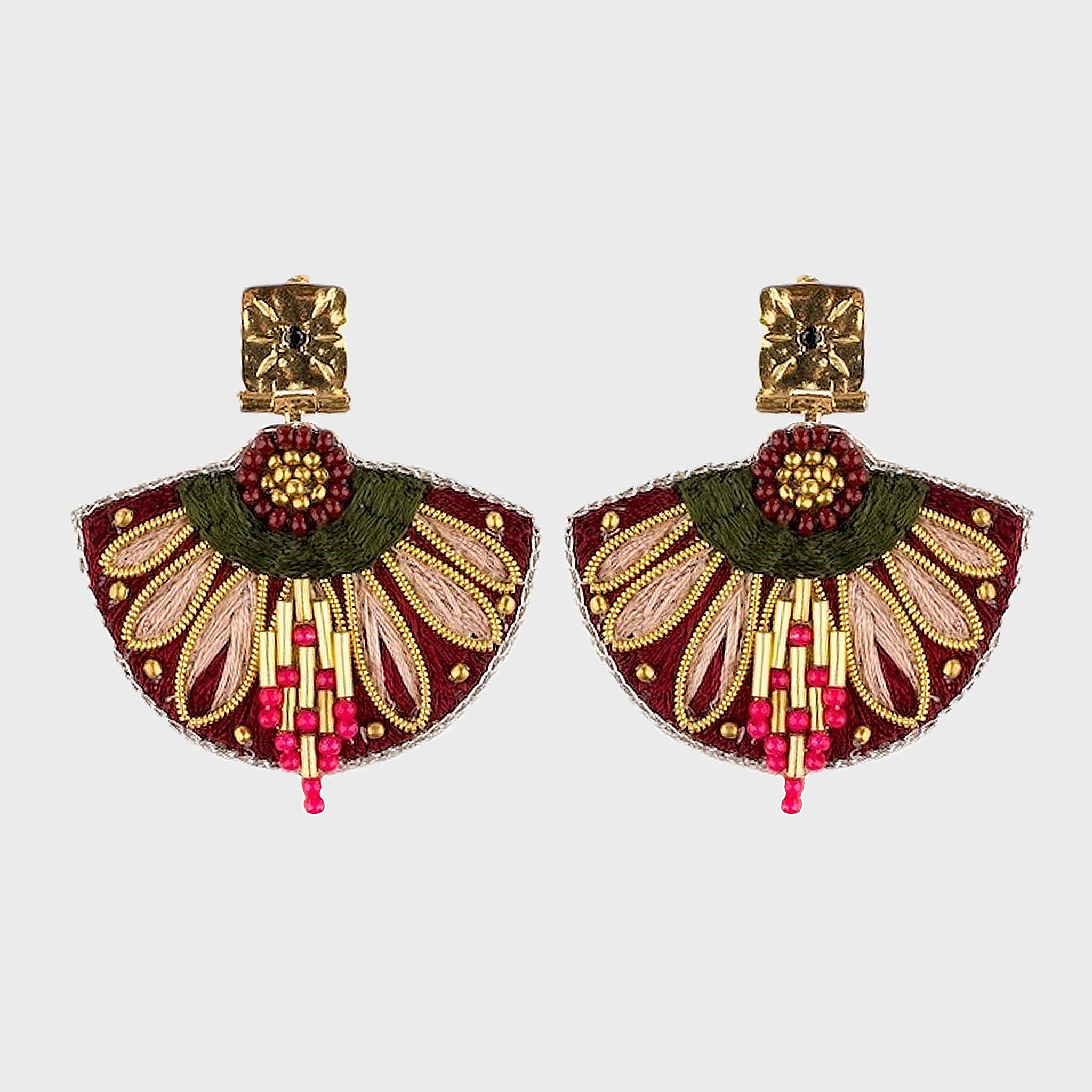 Pair of decorative earrings with gold, green, and pink details on a light gray background