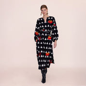 Model wearing the Gondi Black Kaftan in black and white ikat with red floral embroidery, front view