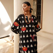 Close-up of the Gondi Black Kaftan ikat pattern and scarlet silk embroidery