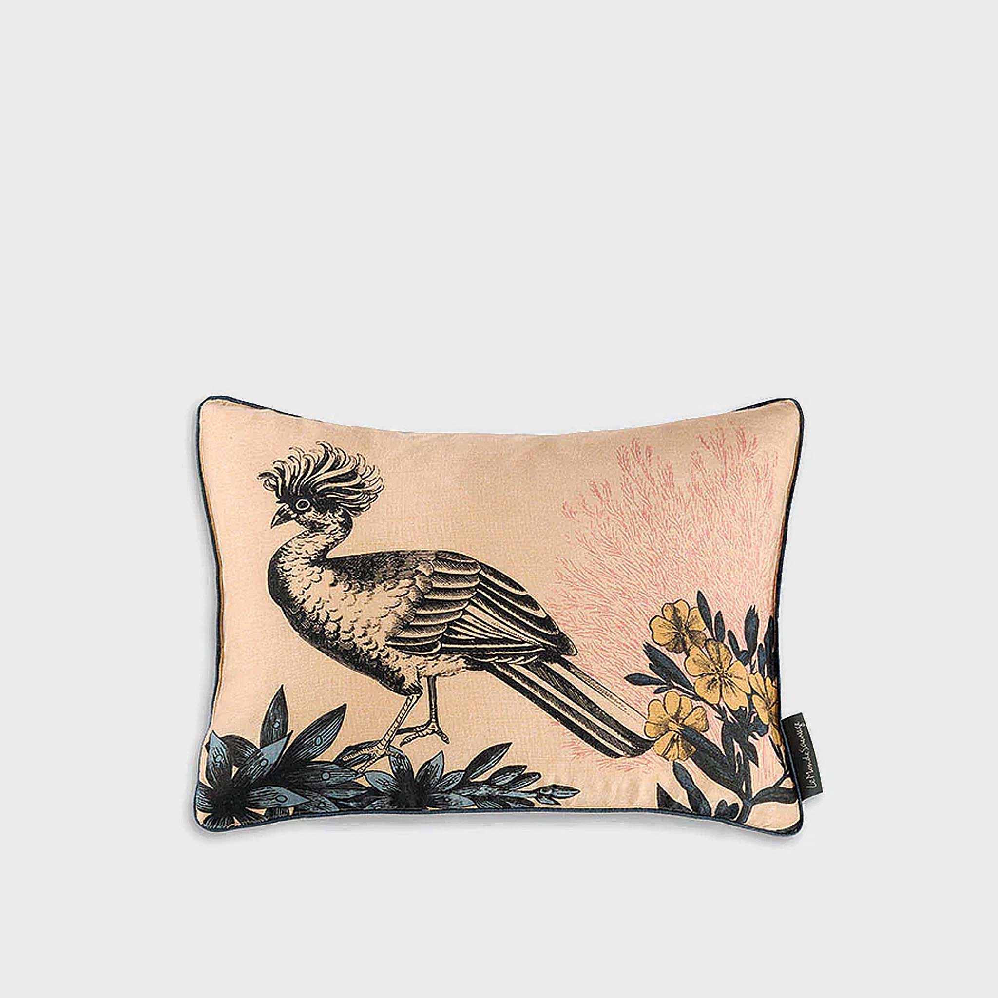 Decorative pillow with bird and floral design on a beige background