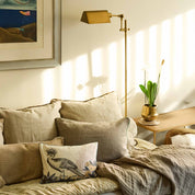 Cozy living room with a sofa, decorative pillows, and a lamp.