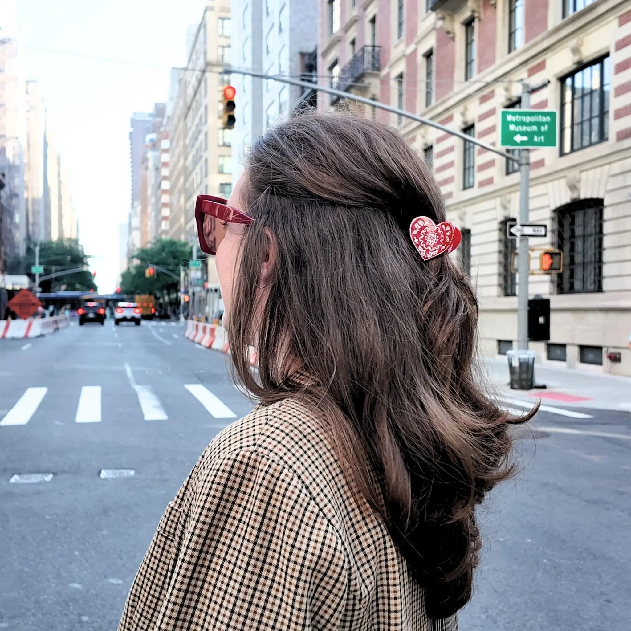 Person with a hair clip on a city street