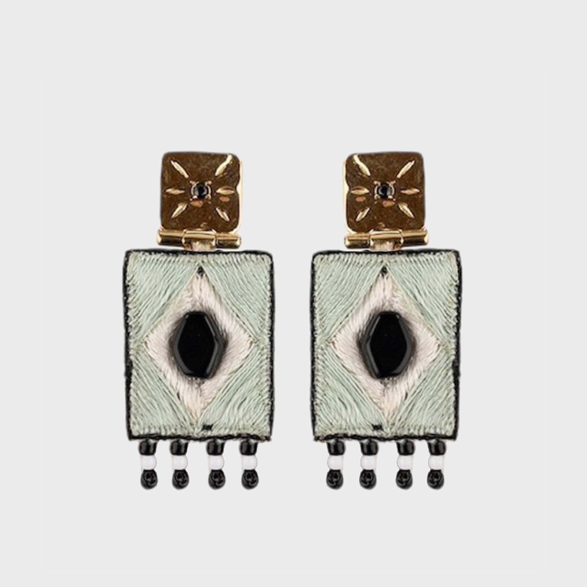 Pair of earrings with geometric design on a light gray background