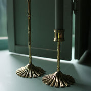 Close-up of the fluted fan bases of the brass bamboo candle holders