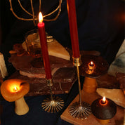 Brass bamboo candle holders with red taper candles on a styled table