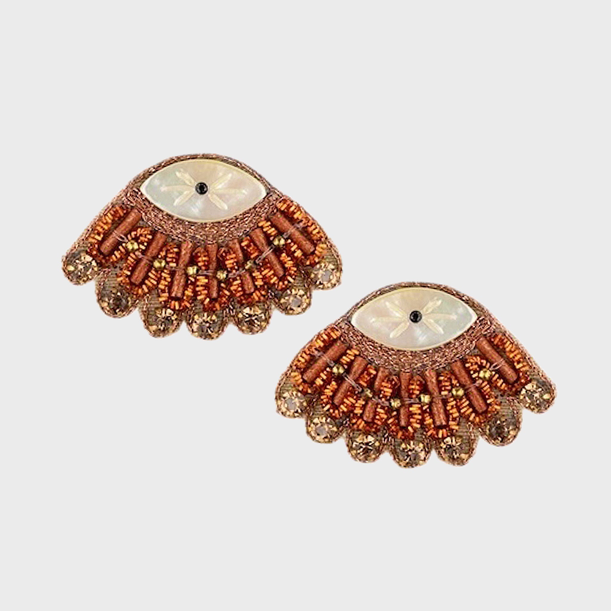Pair of decorative earrings with intricate design on a light gray background