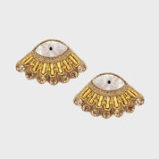 Gold earrings with gemstones on a light gray background