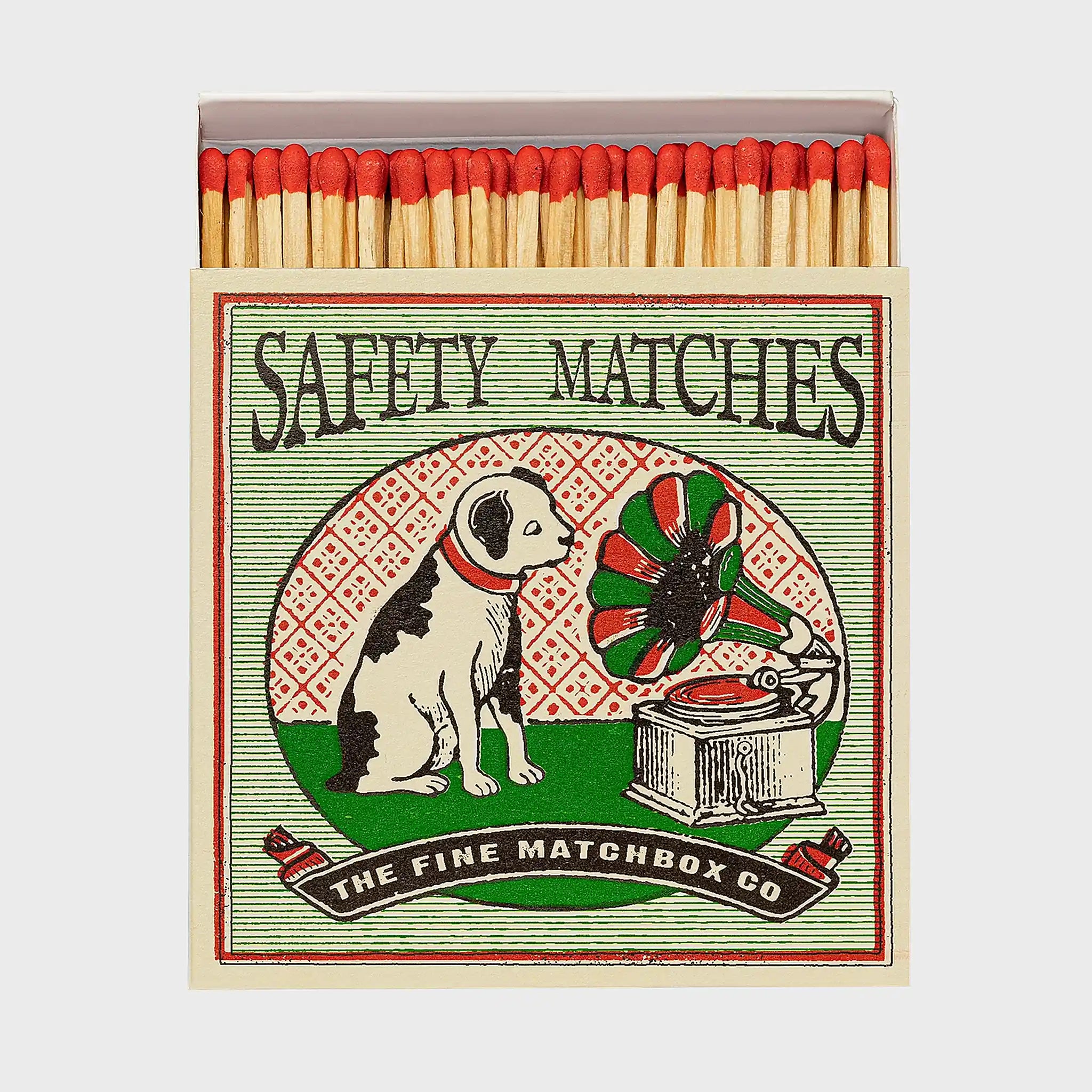 Foto de producto de la caja de fósforos Dog and Gramophone de Aura Collective: ilustración vintage de un perro escuchando un gramófono, con el texto Safety Matches y The Fine Matchbox Co.