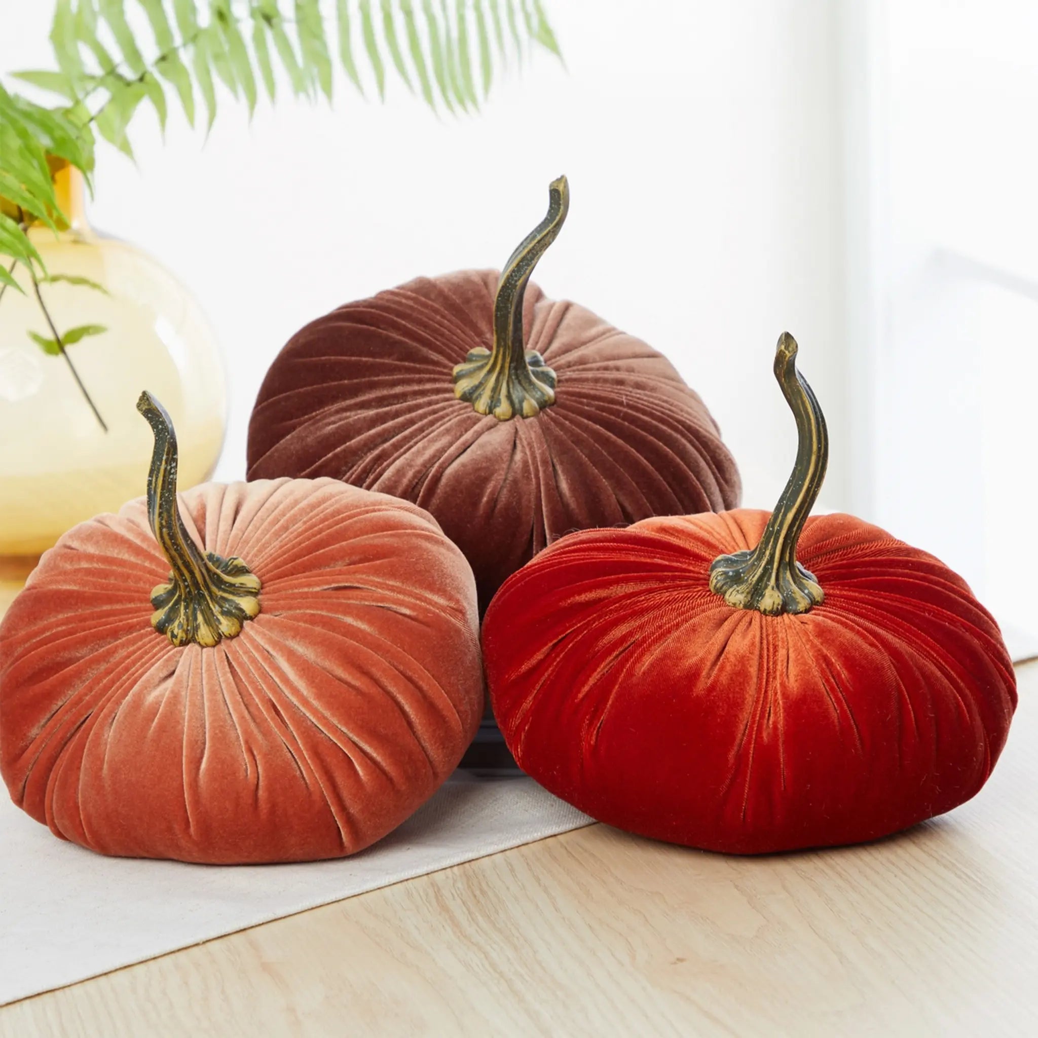 Aura Collective large velvet pumpkins in an assortment of colors including bronze, gold, green, and rust