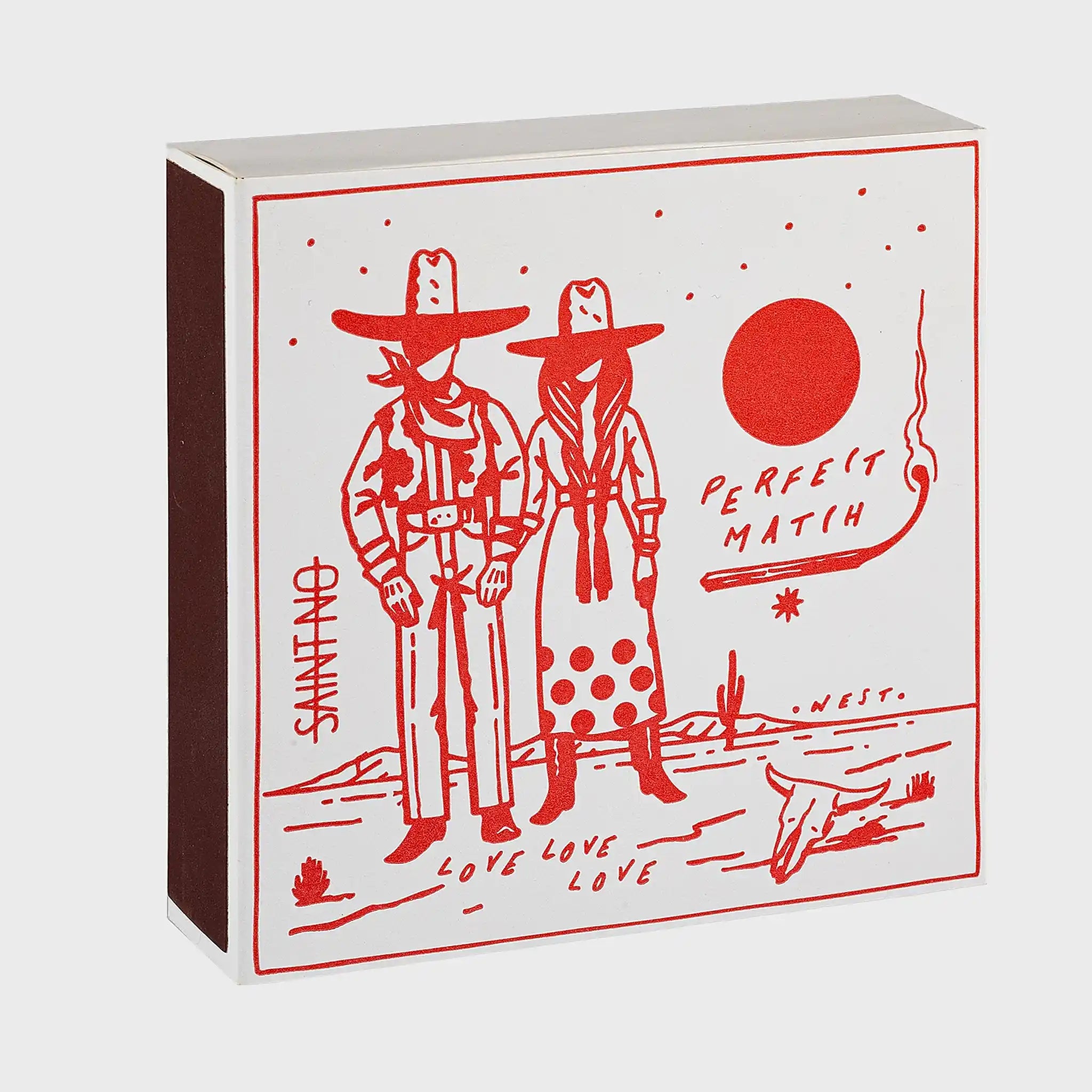 Foto de producto de la caja de fósforos Perfect Match Cowboy Couple de Aura Collective: ilustración en rojo de una pareja de vaqueros bajo el sol, con el texto Perfect Match, Love Love Love y una calavera de toro, de la colección Saint No.