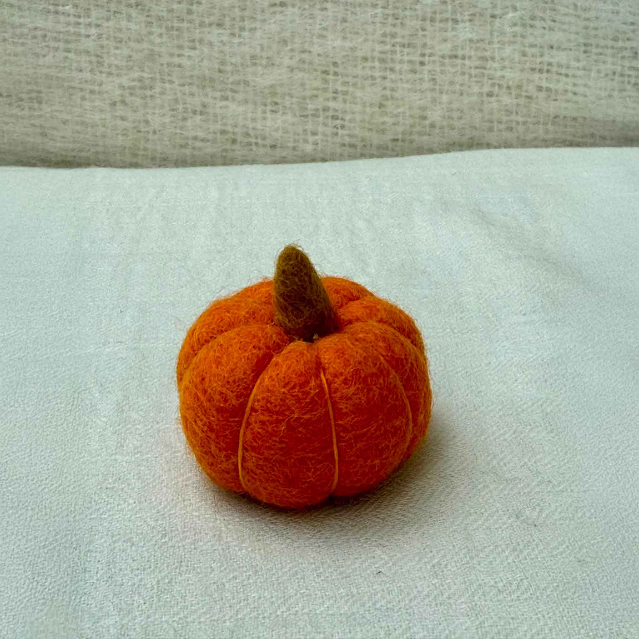 Small Wool Pumpkin in Amber wool with a curled stem