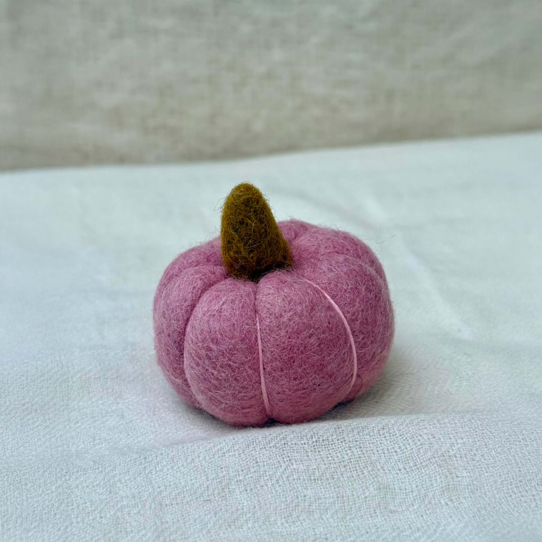 Small Wool Pumpkin in Pink wool with a curled stem