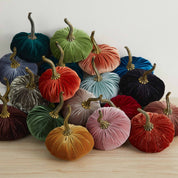 Aura Collective small velvet pumpkins in an assortment of colors including cherry, chocolate, emerald, fern, harvest, olive, and plum