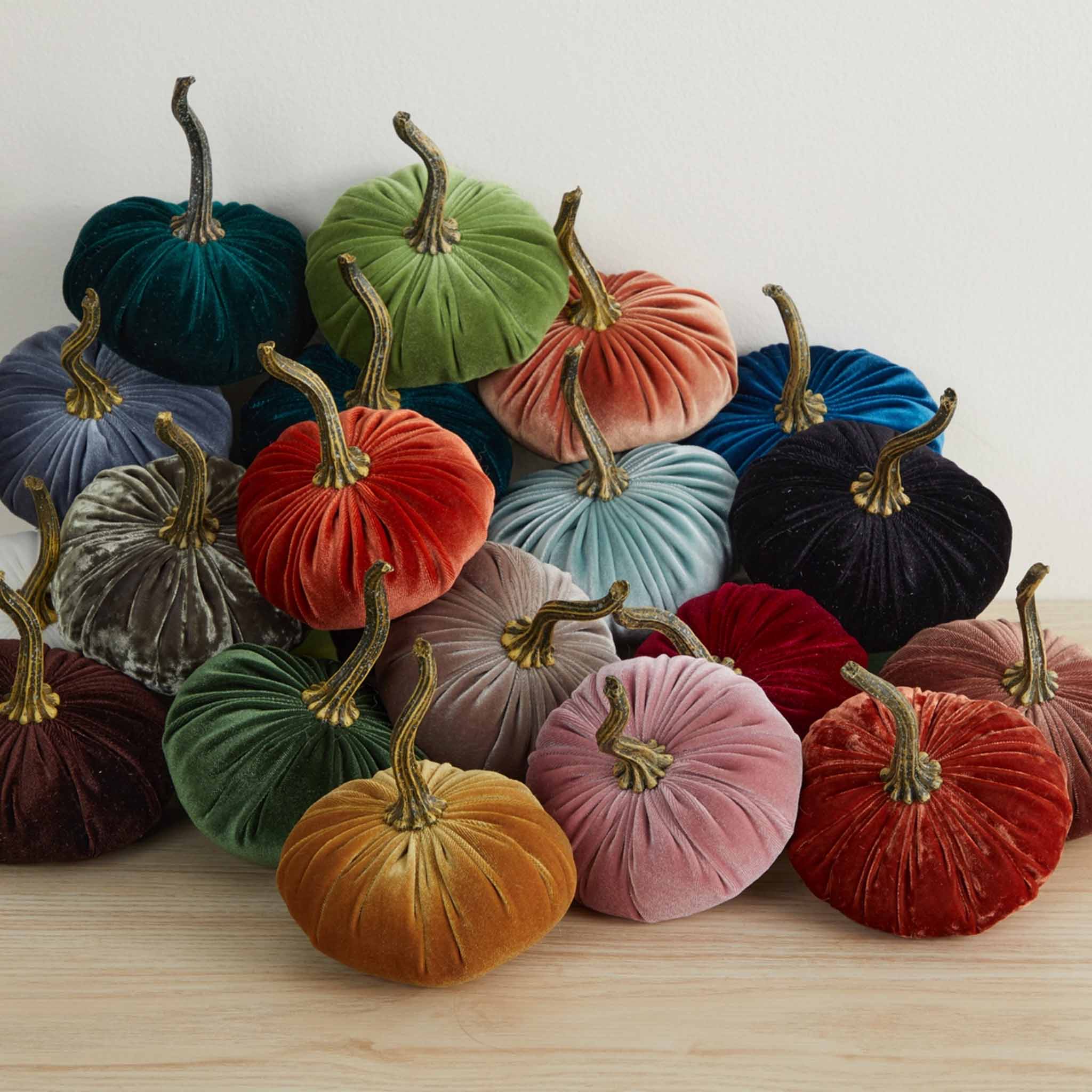 Aura Collective small velvet pumpkins in an assortment of colors including cherry, chocolate, emerald, fern, harvest, olive, and plum