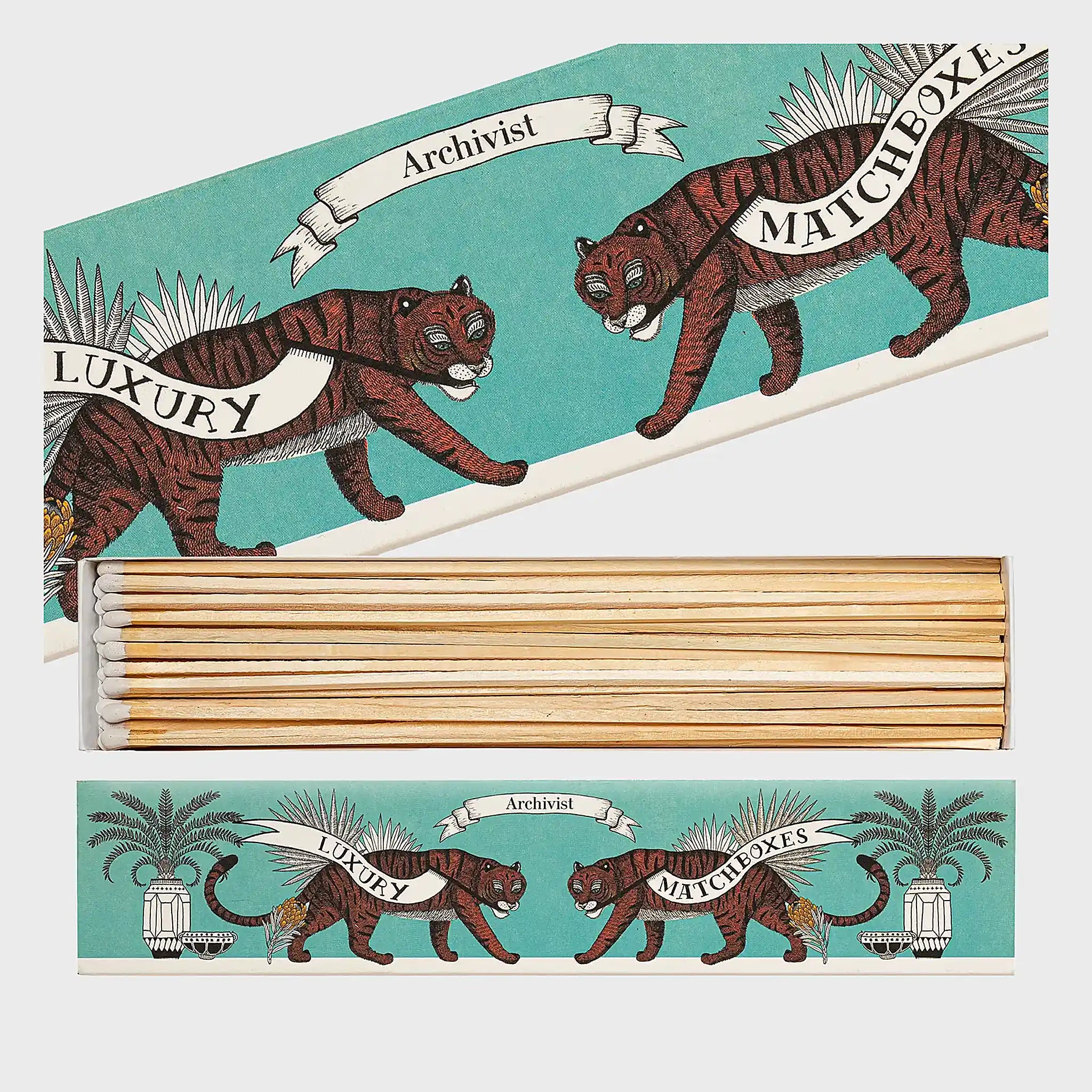 Foto de producto de la caja de fósforos Tiger Long Matches de Aura Collective: caja alargada en tono verde azulado con dos tigres ilustrados y el texto Archivist Luxury Matchboxes, con los fósforos a la vista.